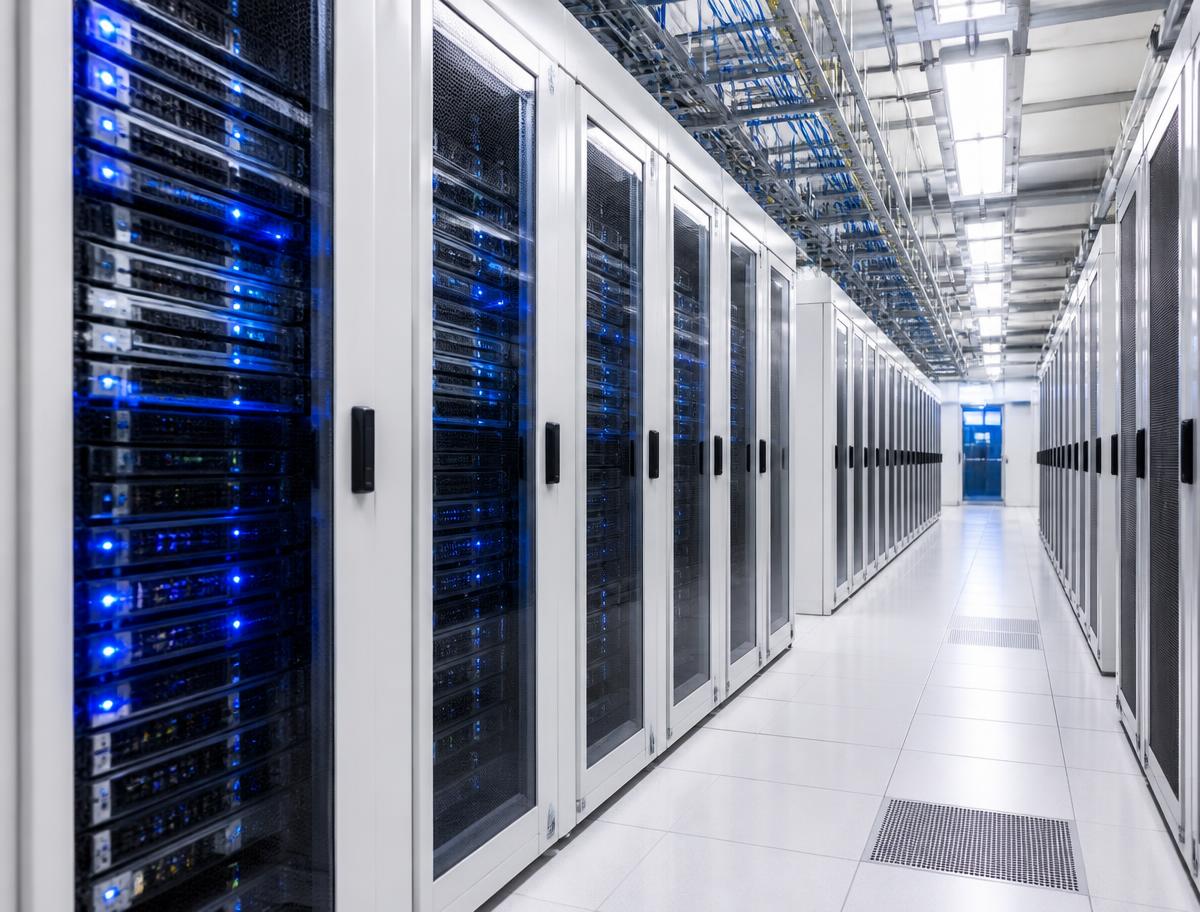 Rows of server racks in a bright data centre supporting cloud workloads